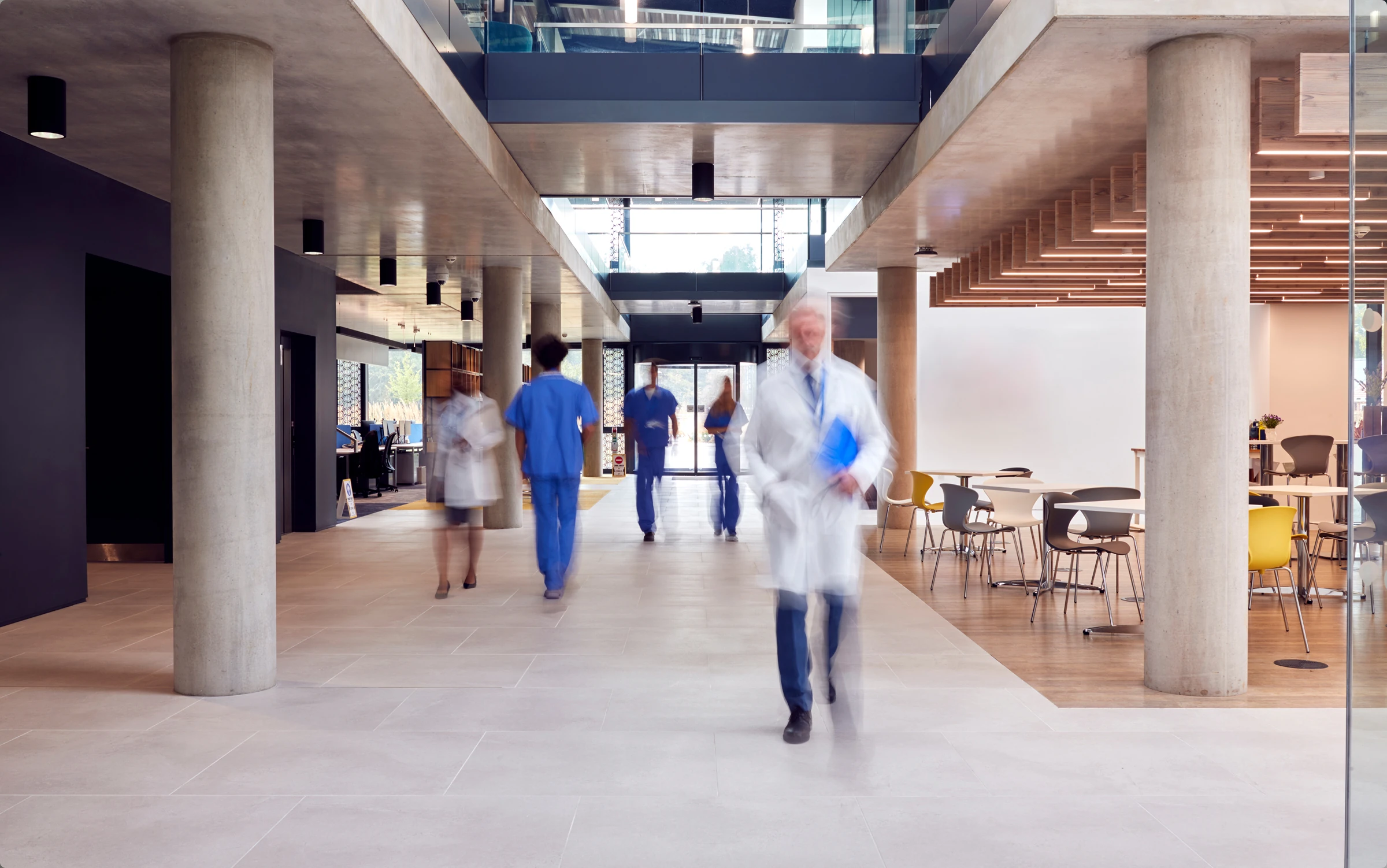 Healthcare workers walk in a hospital