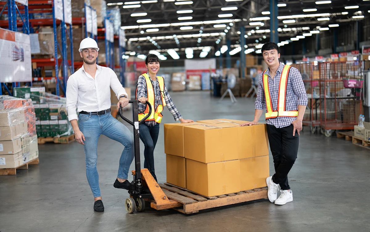 A team moves shipments in a warehouse